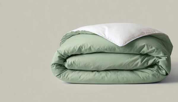 Sage green linen bedding styled on a bed
