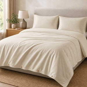 Champagne Luff SilverLining bamboo silk duvet set with matching pillowcases on a made bed in a warm neutral bedroom