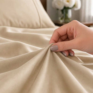 Close-up of a hand gathering smooth Champagne organic bamboo silk fabric